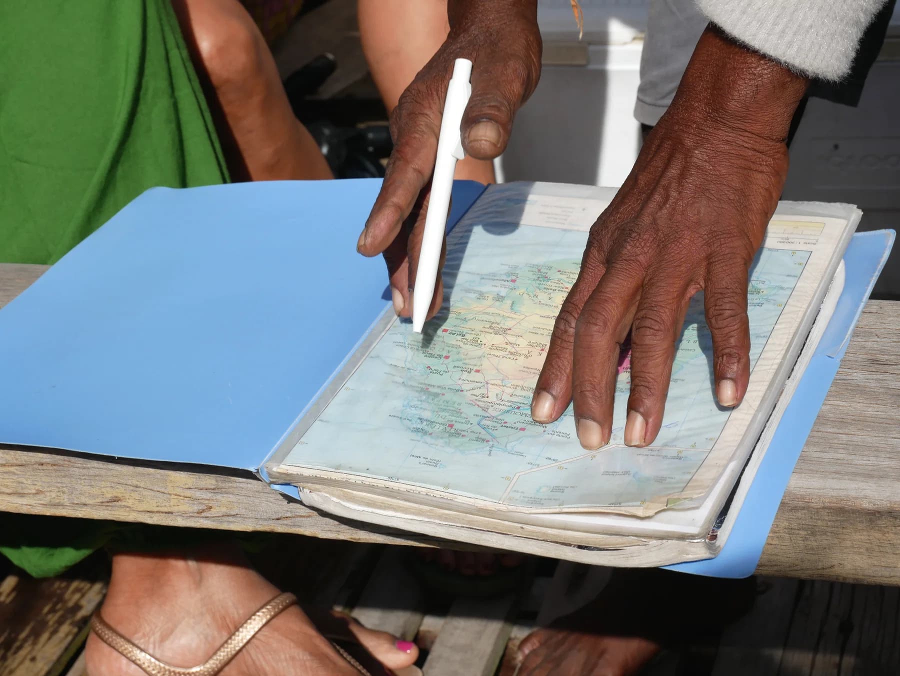 A map being shown to guests aboard the pirogue