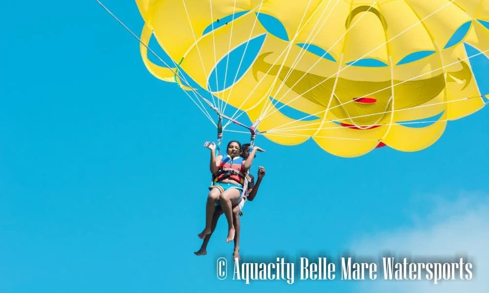 Parasailing above the turquoise water of Belle Mare Lagoon