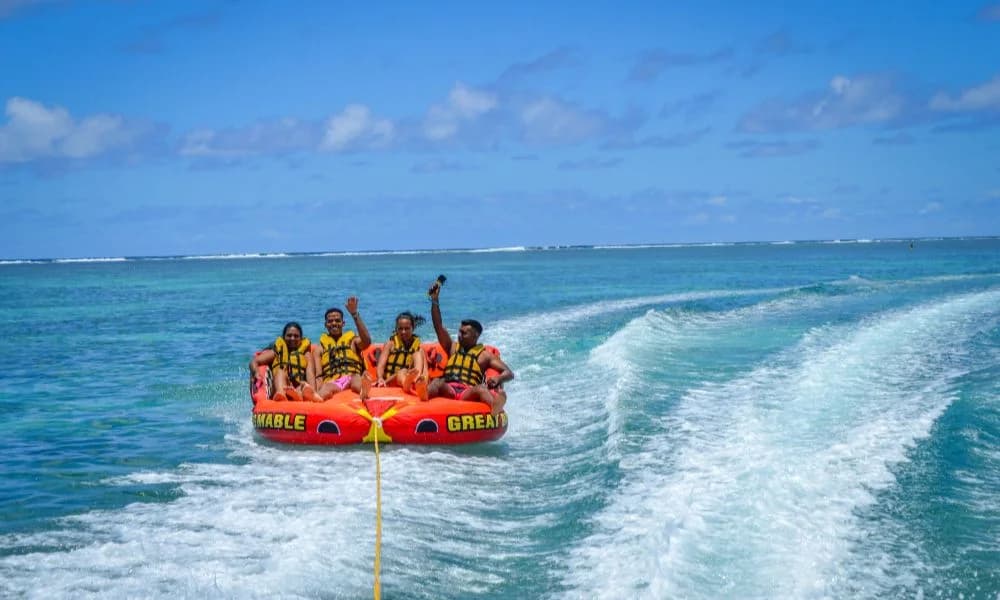 Aquacity guests on a towable tube in Belle Mare Lagoon