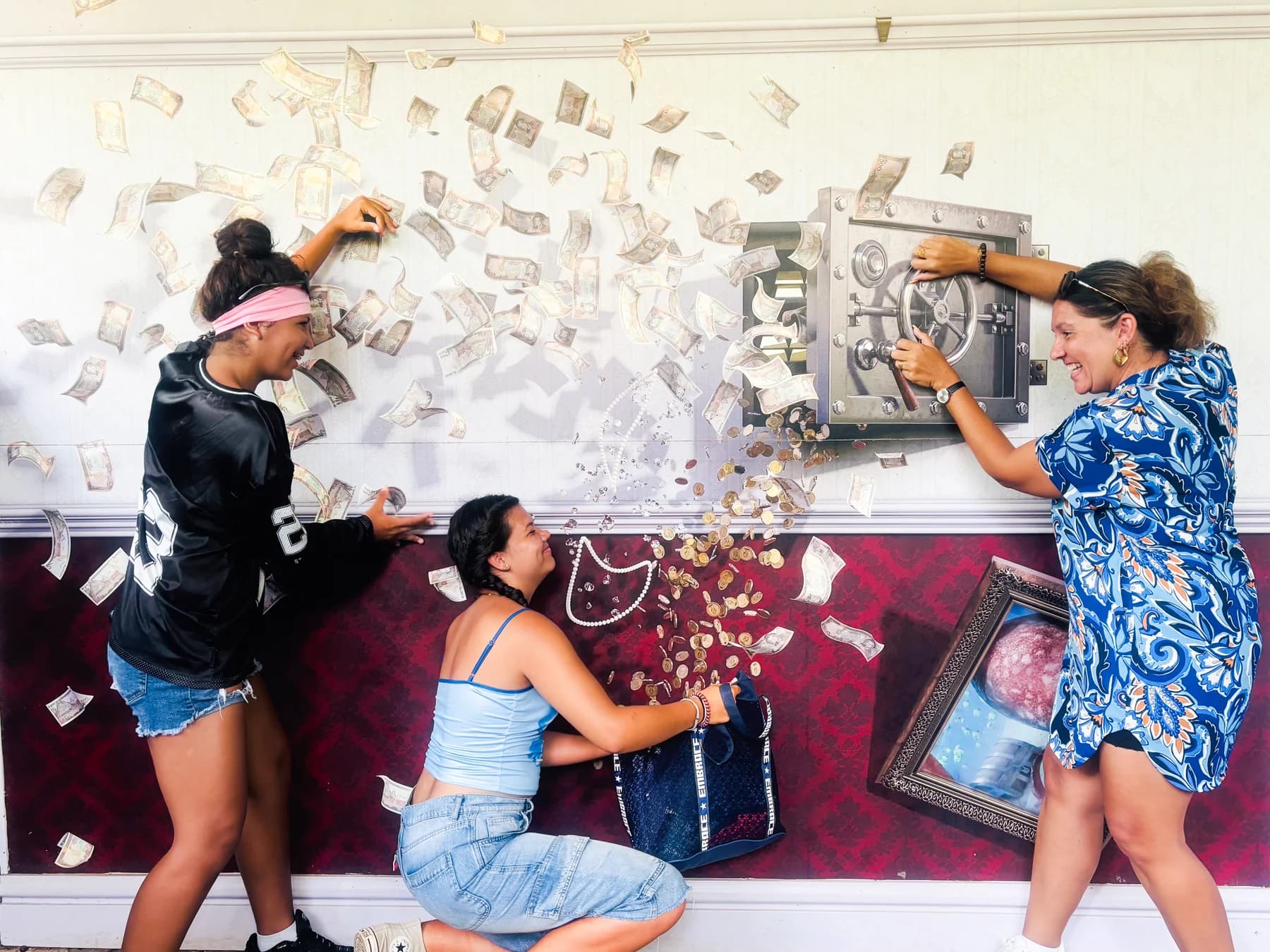 Visitors pose together in an interactive illusion at Curious Mauritius