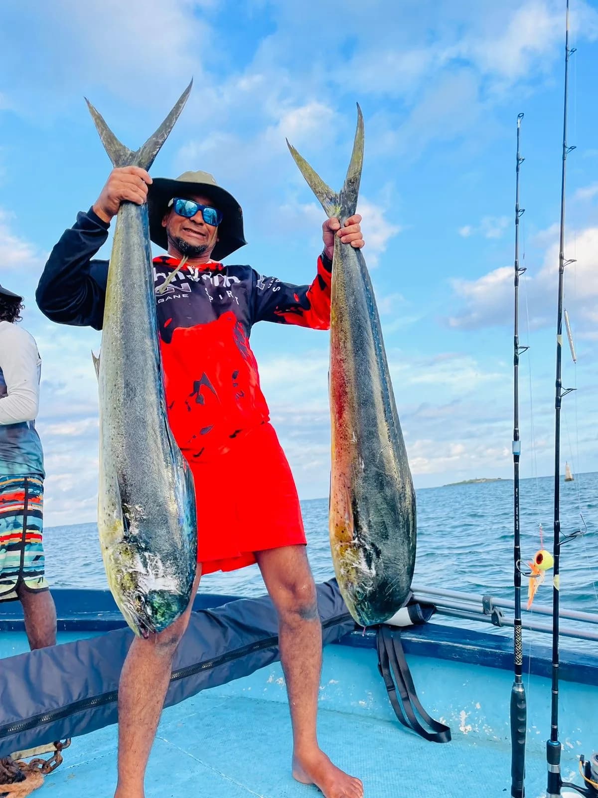 Two dorado held up on board after a catch