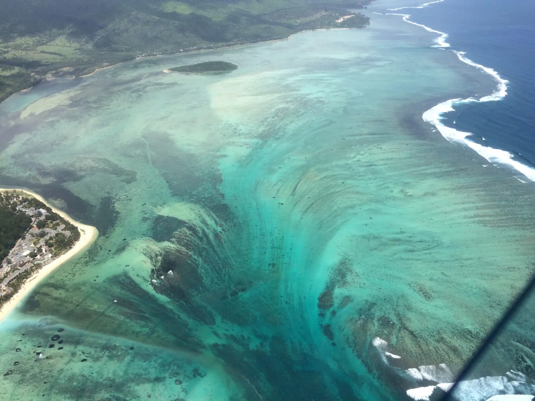 Aerial view of the underwater waterfall illusion beside the Le Morne peninsula