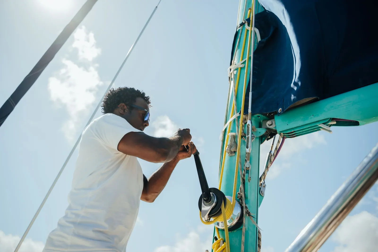 A crew member handling a rope aboard Le Pacha