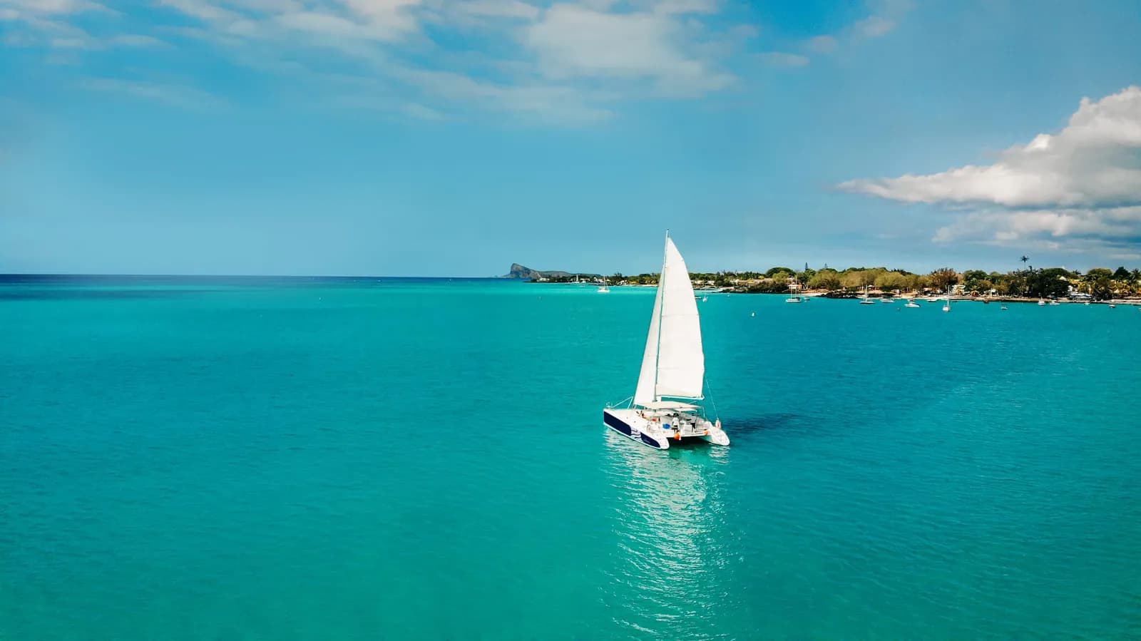 Le Pacha sailing across turquoise water