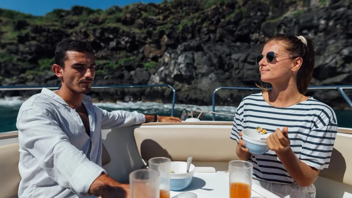 Two guests sharing food aboard a boat