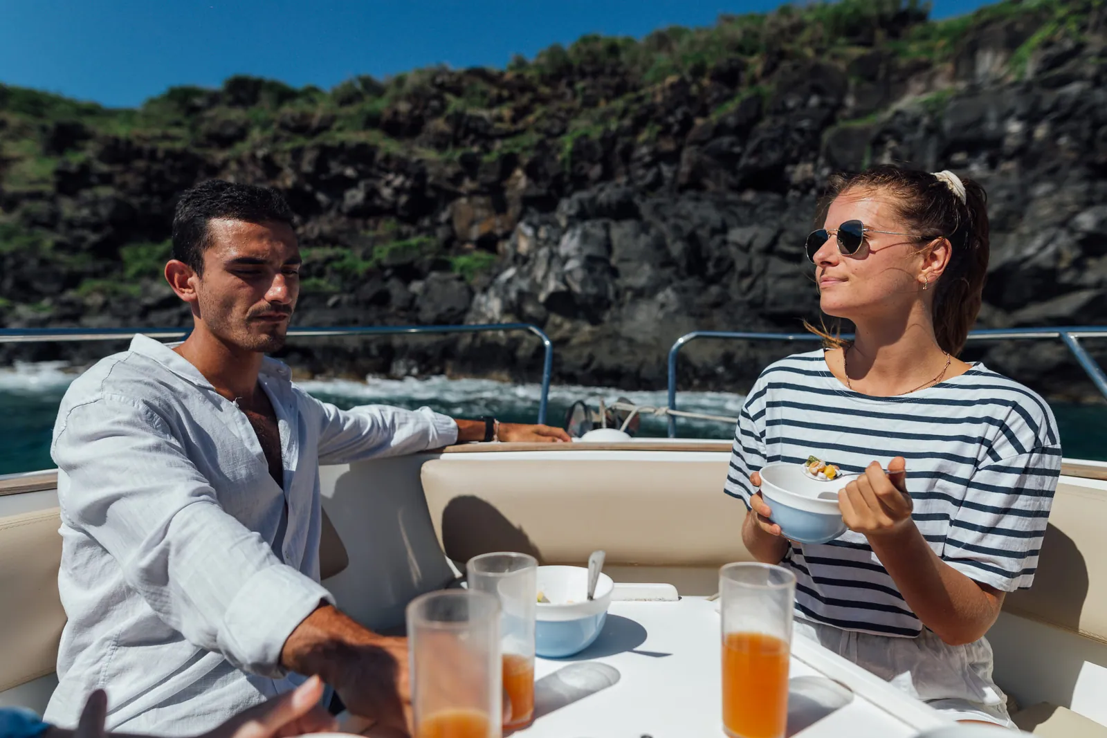 Guests seated beside the island shore