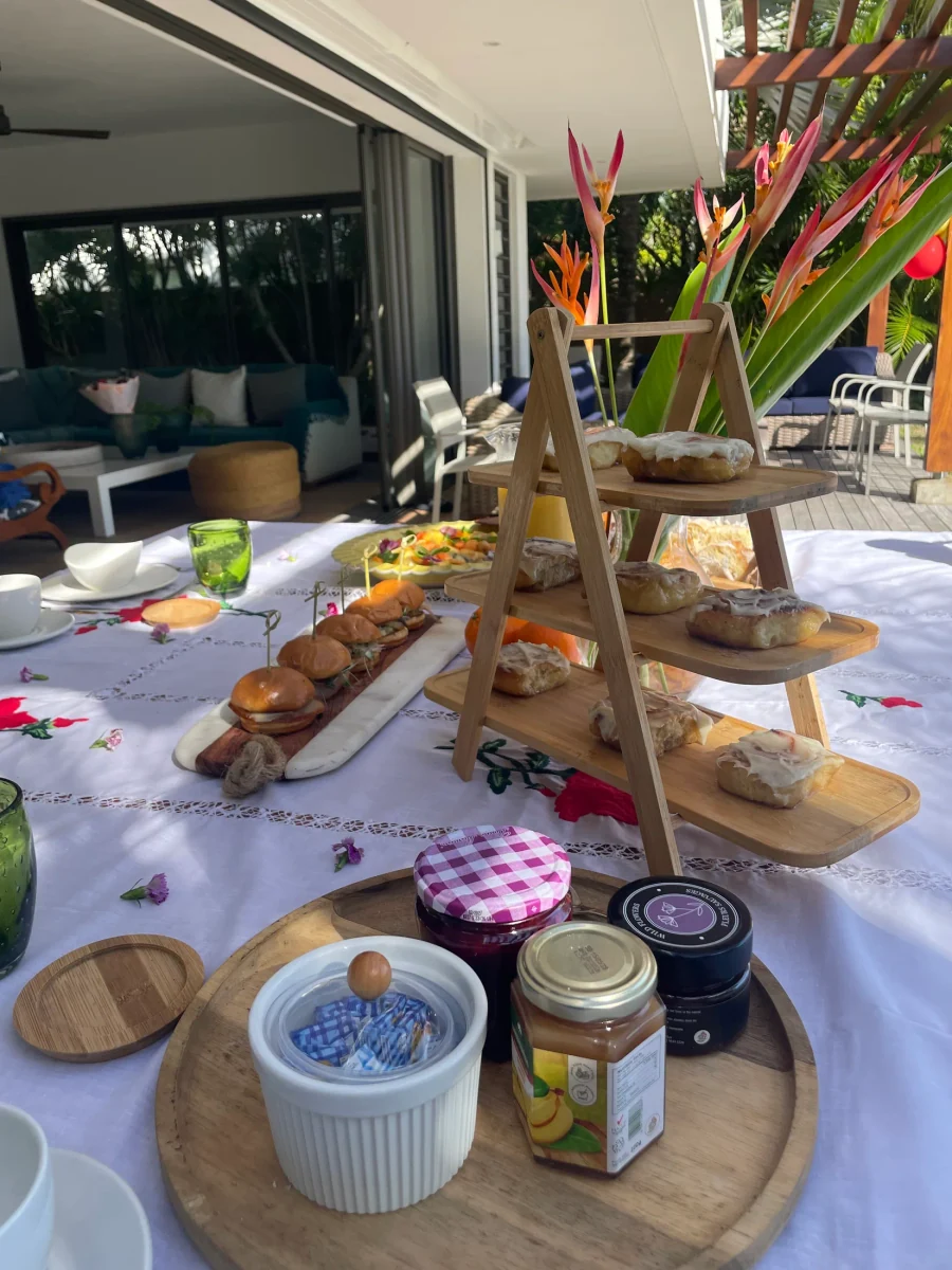 Une table de brunch avec plats, boissons et fleurs